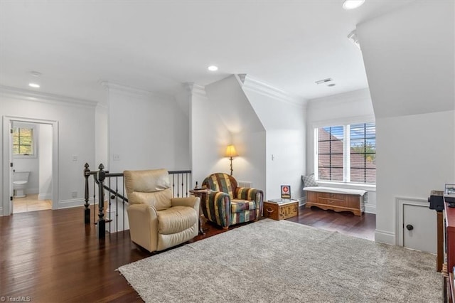 sitting room with dark hardwood / wood-style flooring and crown molding