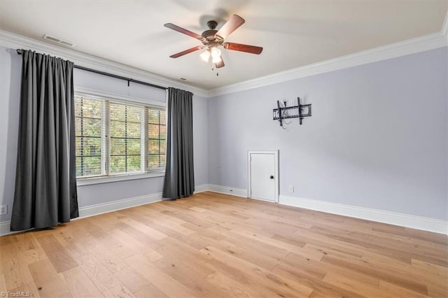 empty room featuring ceiling fan, light wood-type flooring, and ornamental molding