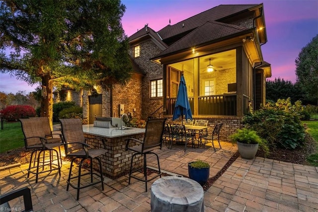 patio terrace at dusk with ceiling fan