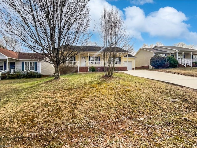 ranch-style home featuring a front lawn, a garage, covered porch, and driveway