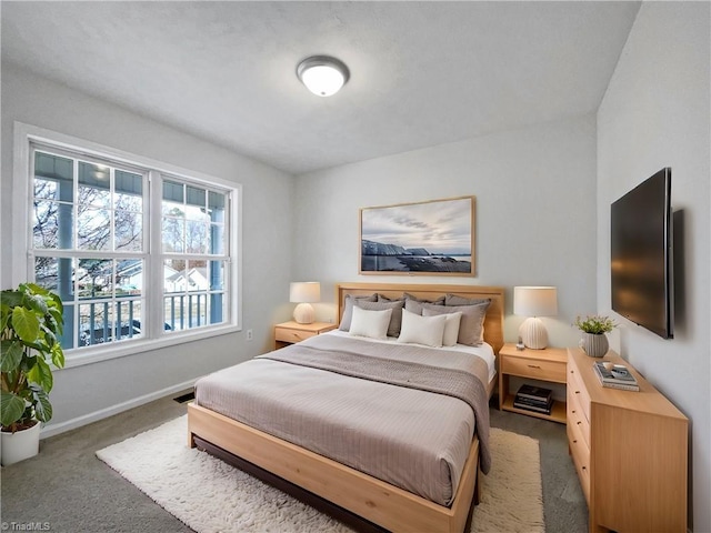 carpeted bedroom featuring baseboards