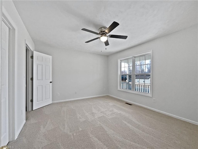 empty room featuring visible vents, ceiling fan, baseboards, and carpet floors