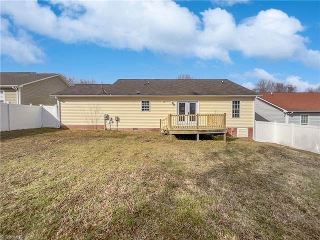 rear view of property featuring crawl space, a lawn, a wooden deck, and a fenced backyard