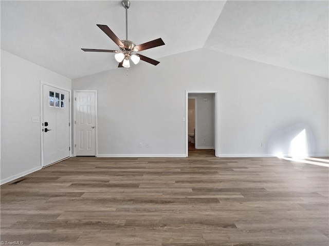 unfurnished living room featuring ceiling fan, baseboards, lofted ceiling, and wood finished floors