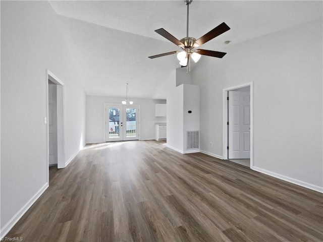 unfurnished living room with high vaulted ceiling, dark wood-style floors, visible vents, and baseboards