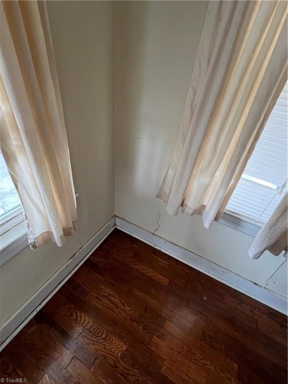 spare room featuring dark hardwood / wood-style flooring