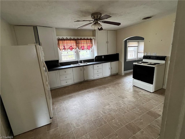 kitchen featuring white cabinetry, sink, ceiling fan, and white appliances