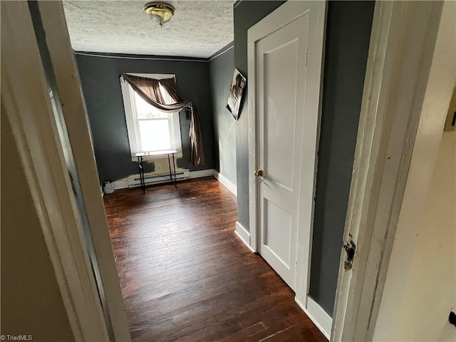 hallway with a textured ceiling, a baseboard radiator, dark hardwood / wood-style floors, and ornamental molding