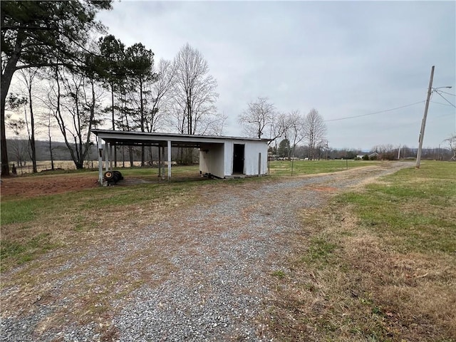 view of outbuilding featuring a lawn and a rural view