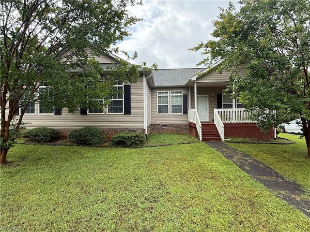 view of front facade featuring covered porch, a front yard, and crawl space