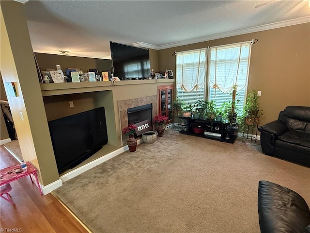 living room with ornamental molding and a tile fireplace
