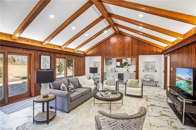 living room with vaulted ceiling with beams, sink, wooden walls, and beverage cooler