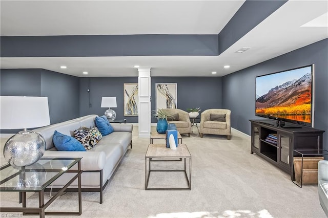 living room featuring light carpet and ornate columns