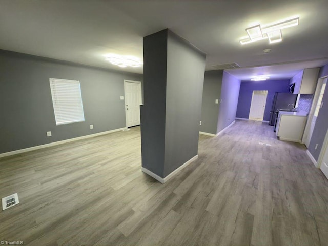 basement with light hardwood / wood-style flooring