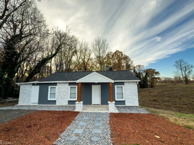 single story home featuring covered porch