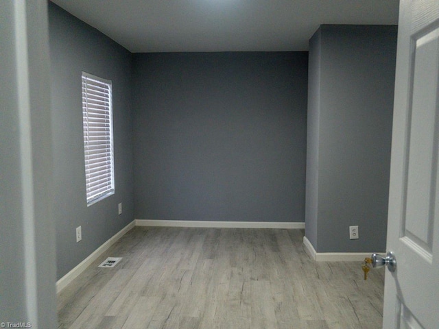 empty room with light hardwood / wood-style flooring