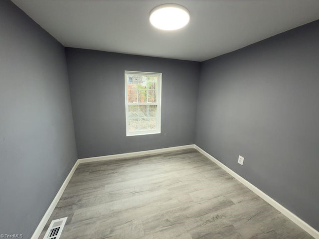 spare room featuring light wood-type flooring