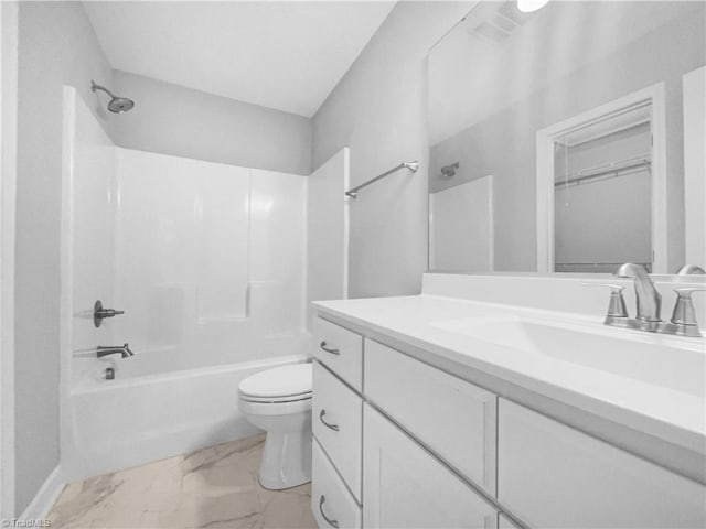 bathroom featuring vanity, toilet, marble finish floor, and shower / bathtub combination