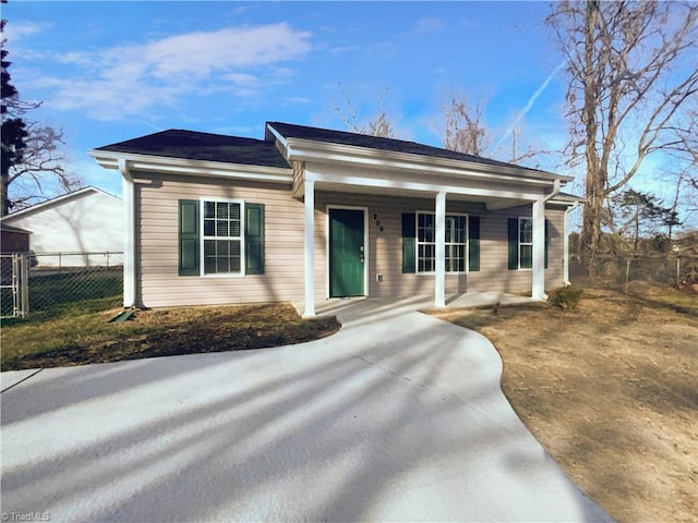 view of front of property with a porch and fence