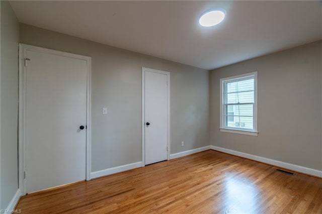 unfurnished bedroom with light hardwood / wood-style floors