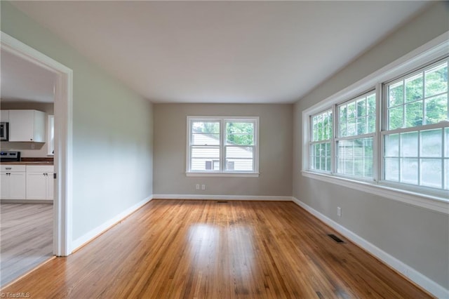 spare room with light wood-type flooring