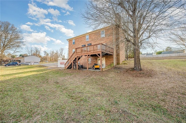 back of property featuring a wooden deck and a yard