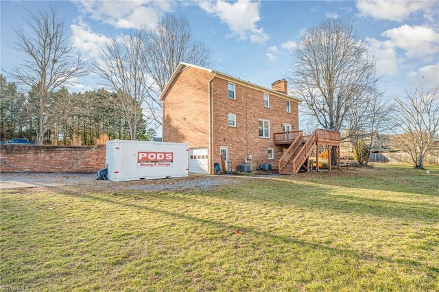 back of house with a yard, central AC, and a deck