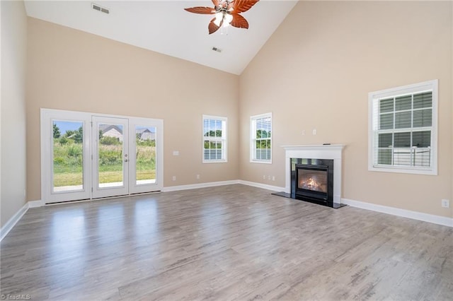 2209 Starfall Dr, Colfax, NC 27235 - unfurnished living room with high vaulted ceiling, ceiling fan, a high end fireplace, and wood finished floors