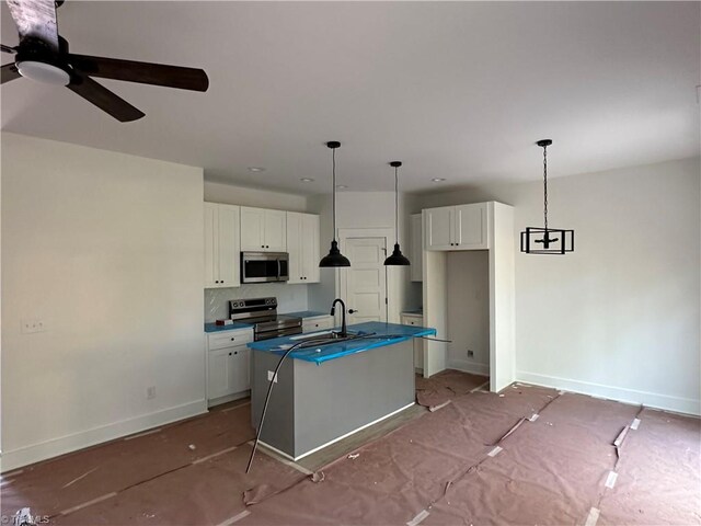 kitchen with white cabinetry, a center island with sink, appliances with stainless steel finishes, and a sink