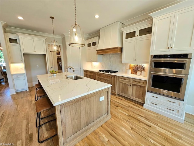 LOT121 N Holden Rd, Greensboro, NC 27410 - kitchen with gas cooktop, double oven, premium range hood, light wood-style floors, and backsplash