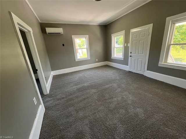 spare room featuring a wall mounted AC and carpet flooring