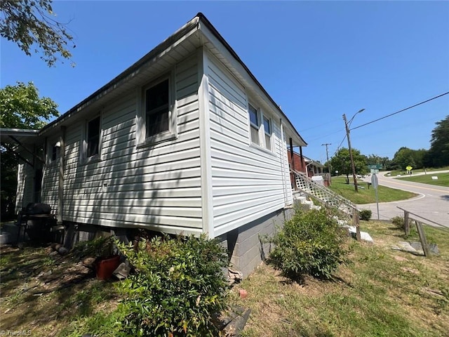 view of property exterior with a lawn