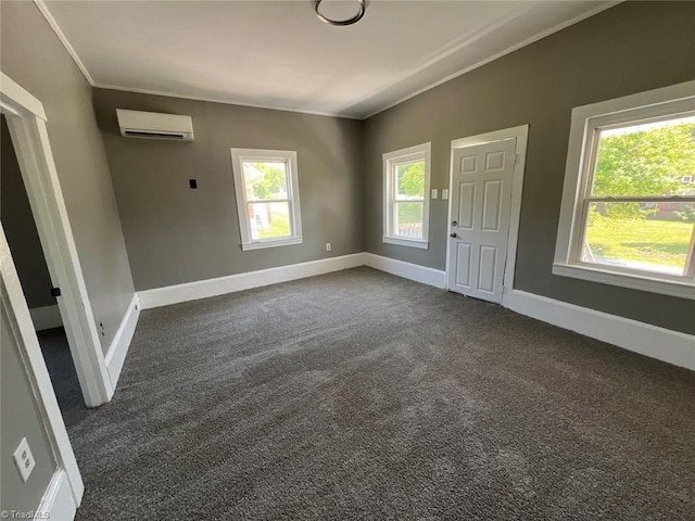 interior space featuring baseboards, ornamental molding, dark colored carpet, and a wall mounted air conditioner