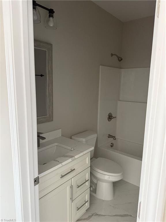 full bathroom with vanity, toilet, marble finish floor, and shower / bath combination