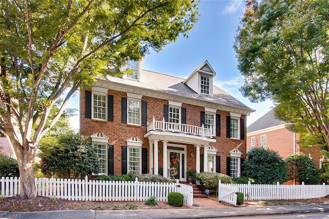 colonial inspired home featuring a balcony