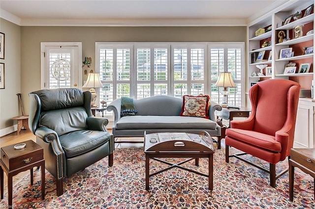 living area featuring crown molding and a healthy amount of sunlight