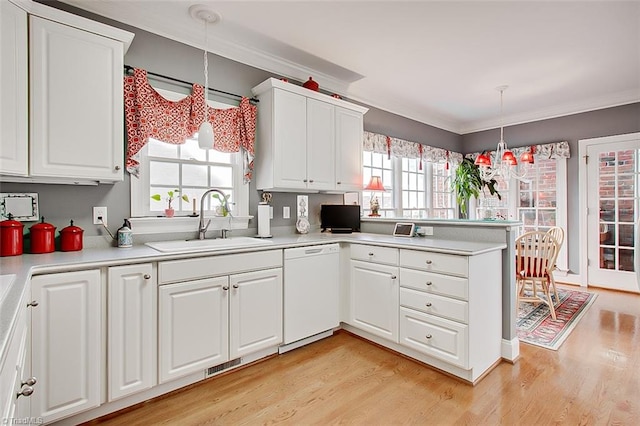 kitchen featuring sink, decorative light fixtures, a wealth of natural light, and dishwasher