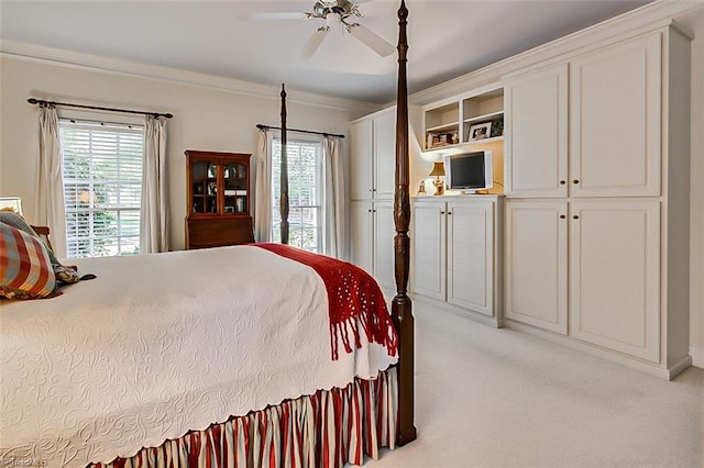 bedroom with ornamental molding, light carpet, and ceiling fan