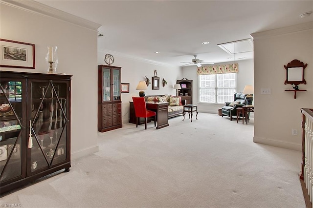 living area with crown molding, light carpet, and ceiling fan