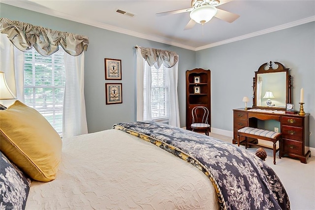 carpeted bedroom featuring ornamental molding, multiple windows, and ceiling fan