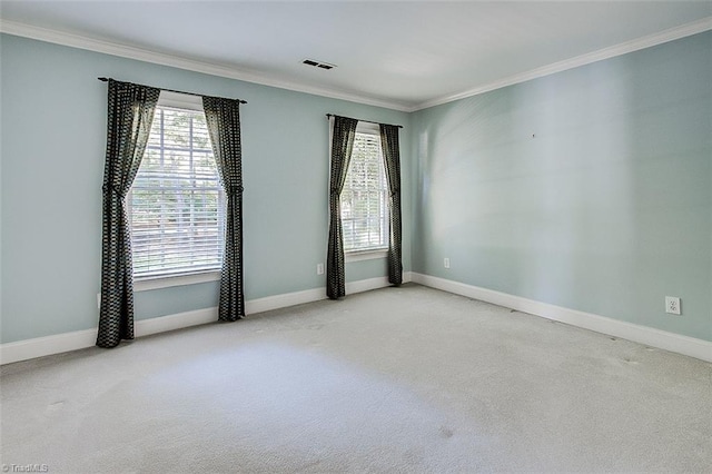 unfurnished room with ornamental molding and light carpet