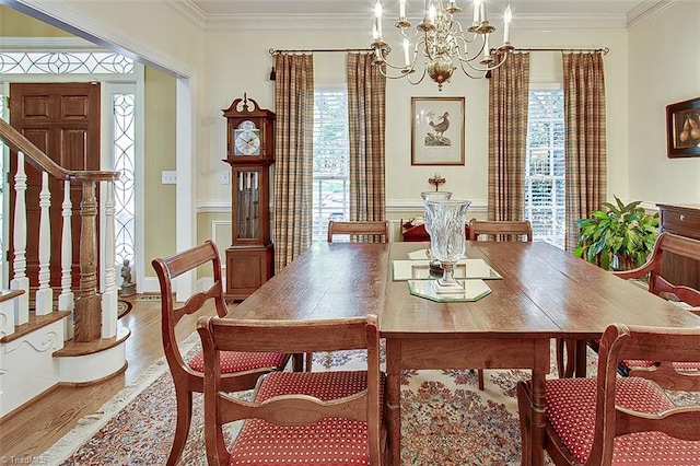 dining room with ornamental molding, hardwood / wood-style flooring, and plenty of natural light