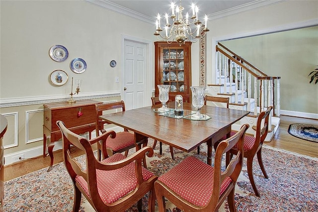 dining space featuring crown molding, a notable chandelier, and hardwood / wood-style floors