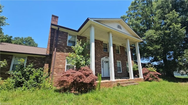9441 County Line Rd, Kernersville, NC 27284 - neoclassical / greek revival house featuring a chimney, brick siding, and covered porch
