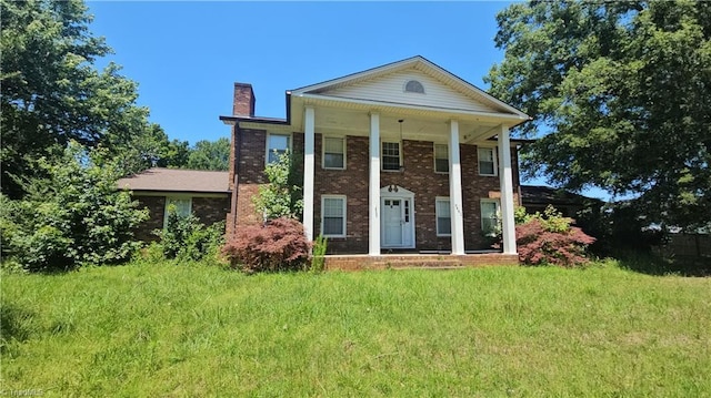 9441 County Line Rd, Kernersville, NC 27284 - greek revival inspired property with a chimney, brick siding, and a porch