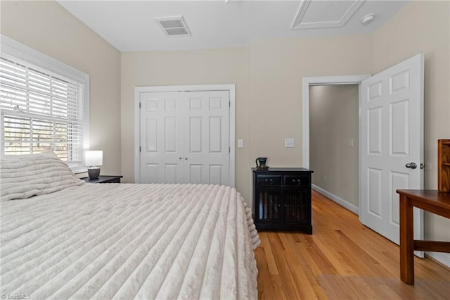 bedroom with light hardwood / wood-style flooring and a closet