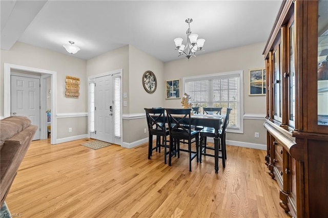 dining space featuring a chandelier and light hardwood / wood-style floors