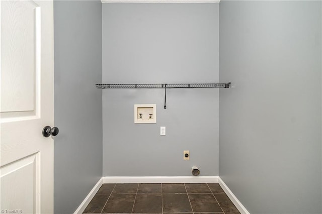 washroom with washer hookup, hookup for an electric dryer, and dark tile patterned flooring