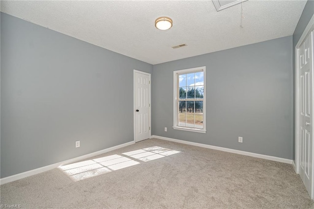 unfurnished bedroom featuring light carpet, a closet, and a textured ceiling