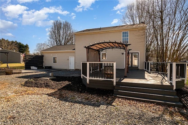 rear view of house featuring a deck and a pergola